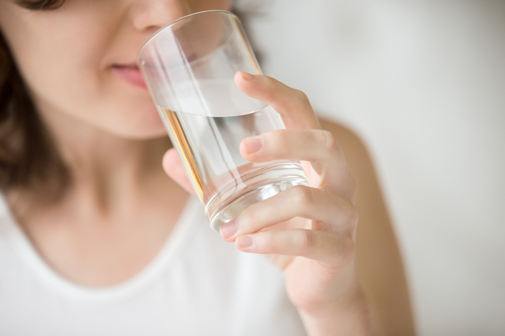 someone drinking a glass of water